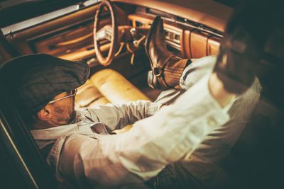 Low angle view of man sitting in car