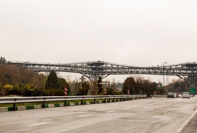 Bridge in city against clear sky