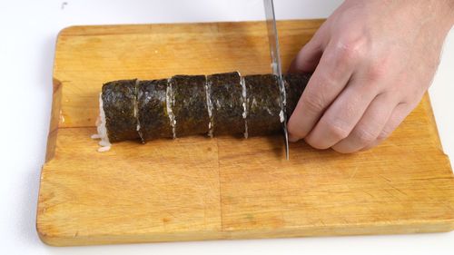 Cropped image of person preparing food on cutting board