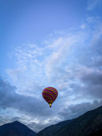 Low angle view of balloons flying against sky