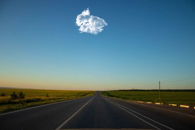 View of country road against clear blue sky