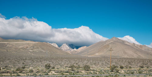 Panoramic view of mountains against blue sky