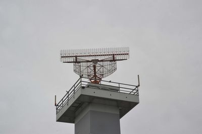 Low angle view of communications tower against sky