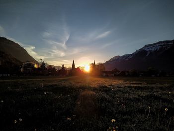 Scenic view of field against sky during sunset