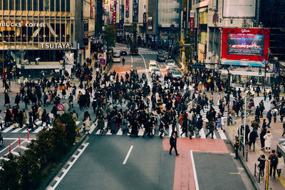 Group of people walking on road in city