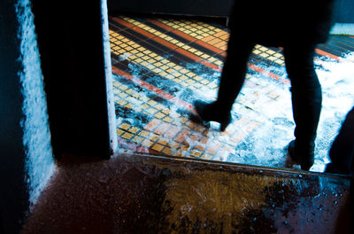 Low section of man walking in corridor