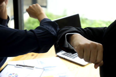 Midsection of man using mobile phone