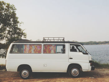 Vintage car on road against clear sky