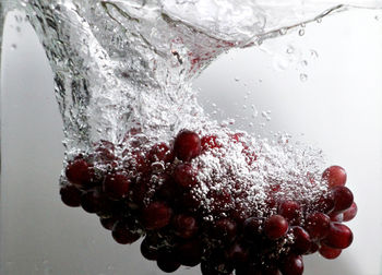 Close-up of frozen glass against white background