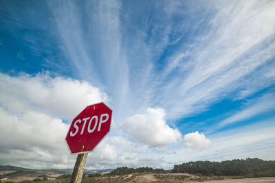 Road sign against blue sky