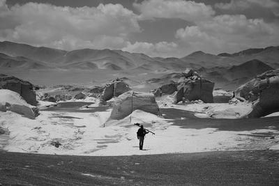 Full length of person on snowcapped mountains against sky