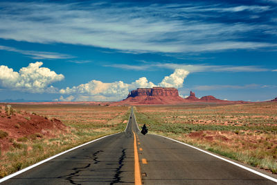 Road passing through landscape against sky