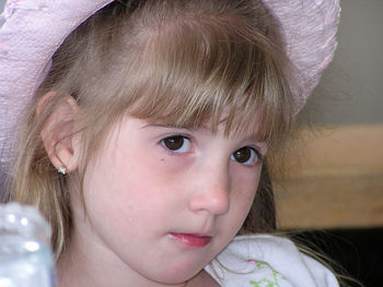 Close-up portrait of cute girl at home