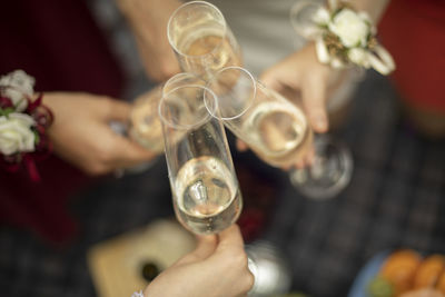 Close-up of hand holding champagne flute