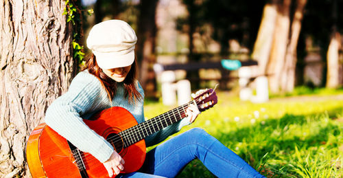 Midsection of person playing guitar