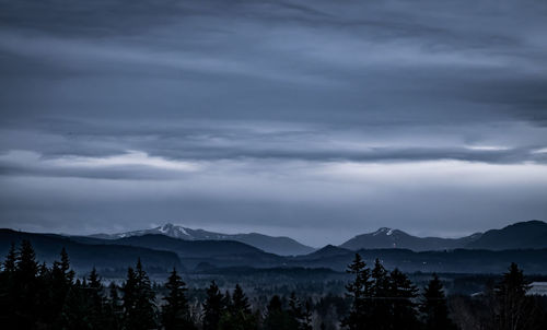 Scenic view of mountains against sky at dusk