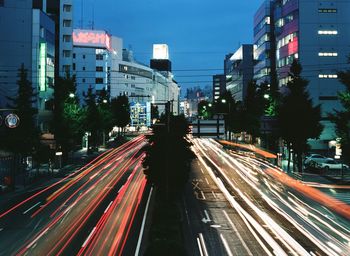 Light trails on road along buildings at night