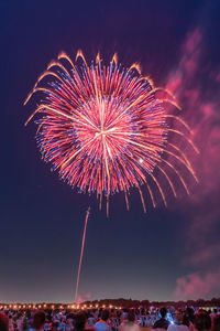 Low angle view of firework display at night