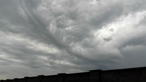 Low angle view of building against cloudy sky