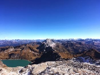 Scenic view of mountains against clear blue sky