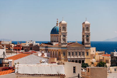 Buildings in city against clear sky