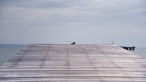 Pier over sea against sky