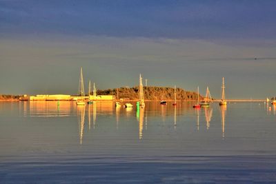 Sailboats in sea against sky