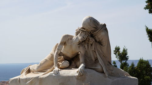 Low angle view of statue against sky