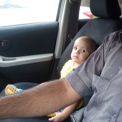 Midsection of man sitting in car