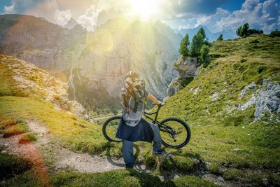 Man with bicycle on mountain