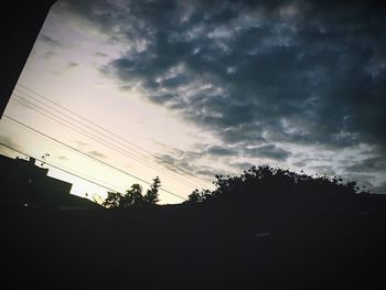 Low angle view of silhouette trees against sky at sunset