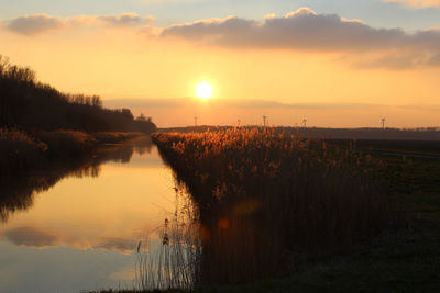 Scenic view of lake at sunset