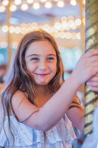 Happy girl having fun on carousel