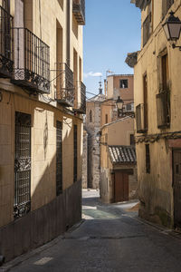 Empty alley amidst buildings in city