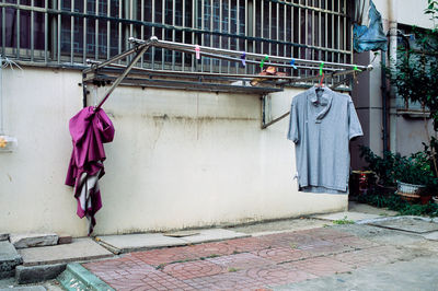 Clothes hanging on wall by building