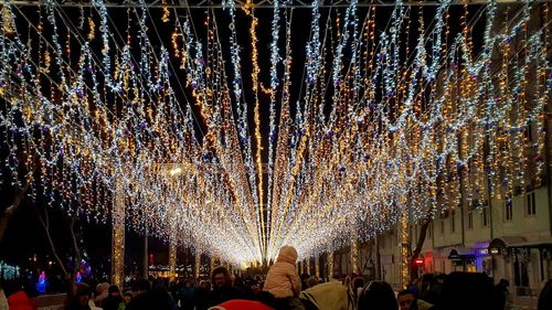 Crowd at illuminated christmas lights in city