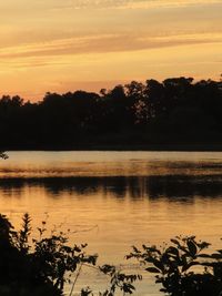 Scenic view of lake against sky during sunset