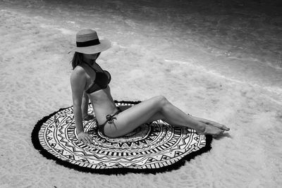 High angle view of woman sitting on swimming pool