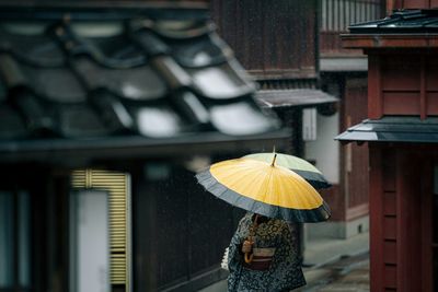 Women  standing on wet roof of house