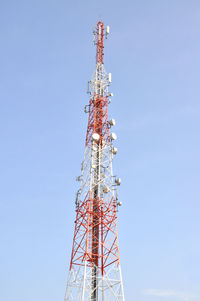 Low angle view of communications tower against clear blue sky