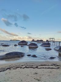 Scenic view of blue stone beach against sky during sunset at natuna island, indonesia