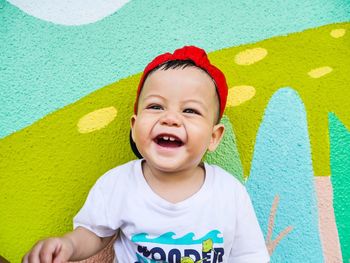 Portrait of cute boy against wall