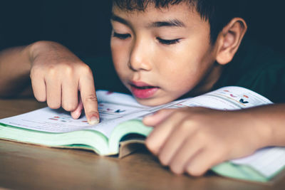 The boy was reading a book in a quiet room, concept read a book.