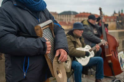 Group of people playing guitar in city