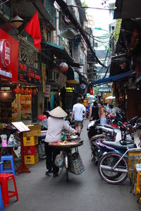 Rear view of man walking on narrow street