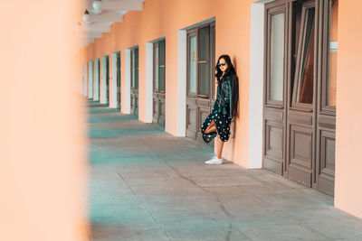 Woman standing at entrance of building