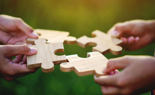 Cropped hand holding jigsaw puzzle