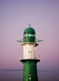 Low angle view of lighthouse at beach against sky