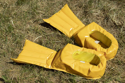 High angle view of yellow plastic bag on grass