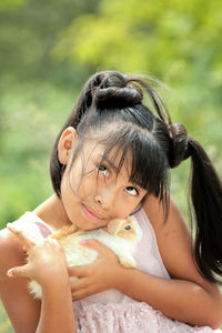 Portrait of cute girl smiling with a rabbit 